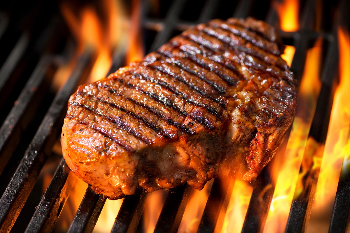 Sizzling steak on a grill